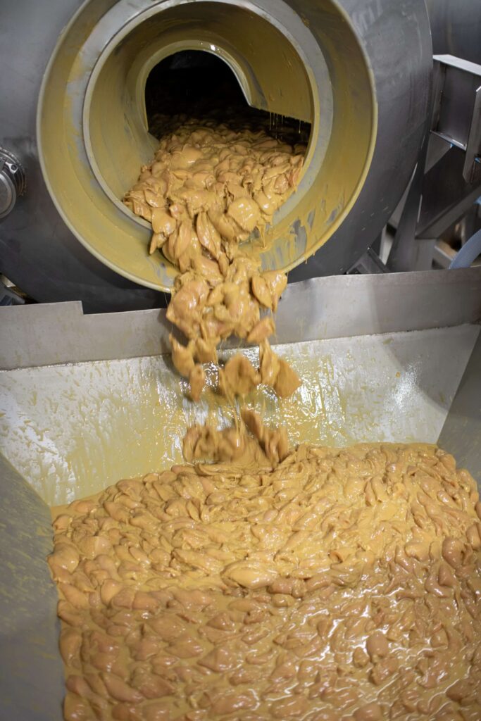 marinated chicken being processed